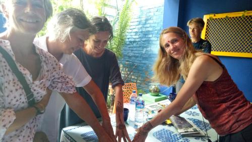 a group of women standing around a table at The Coral Tree Boutique Homestay in Agra