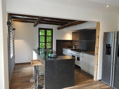 a kitchen with a counter and a refrigerator at Forester in Malmedy
