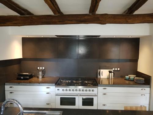 a kitchen with a stove and a counter top at Forester in Malmedy