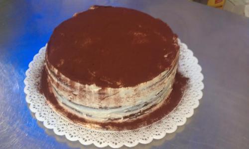 a chocolate cake on a plate on a table at Hotel Giannino in Porto Recanati