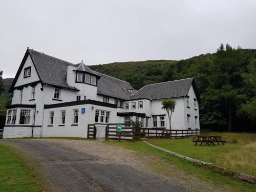 a large white building with a black roof at Lochranza Youth Hostel in Lochranza