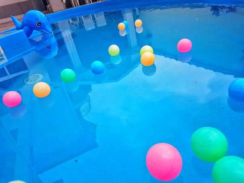 a bunch of balls floating in a swimming pool at Apartment Cace in Kumanovo
