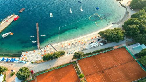 an aerial view of a beach with boats and umbrellas at Valamar Tamaris Resort in Tar
