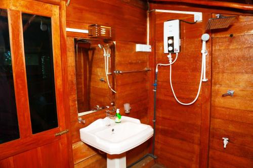 a bathroom with a sink and a shower at Lake Villa Resort in Tissamaharama