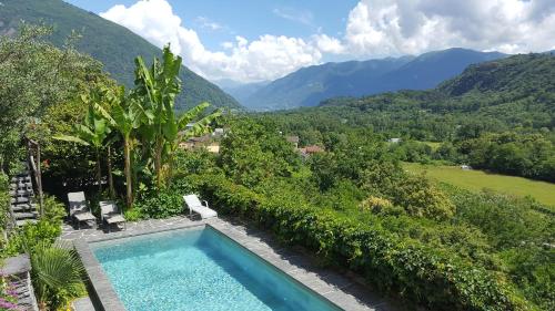 a swimming pool with a view of mountains at Casa Aries & Studio Aurora, Cavigliano in Cavigliano