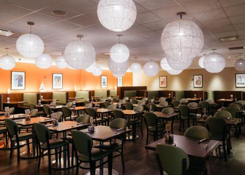 a dining room with tables and chairs and lights at Hotel Casino New Nouveau Brunswick in Moncton
