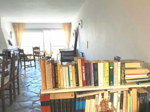 a pile of books sitting on a shelf at Sea-view maisonette at Sounio in Sounio