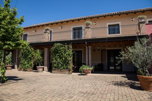 a house with a balcony on top of a brick courtyard at Luxardotel in Rome