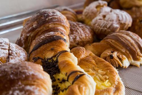 a bunch of pastries sitting on a table at Luxardotel in Rome