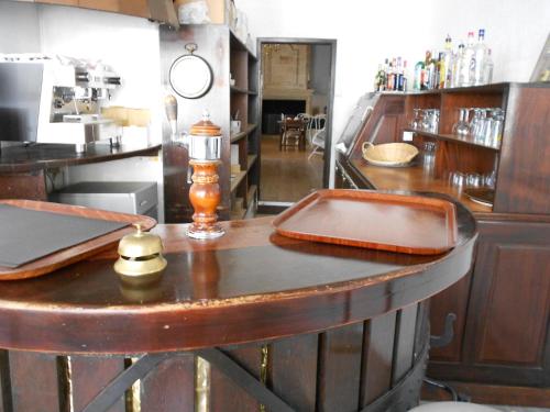 a bar in a restaurant with a counter top at Grand Hôtel in Sainte-Foy-la-Grande