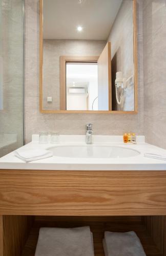 a bathroom with a white sink and a mirror at Hotel Villa Gracia in Budva