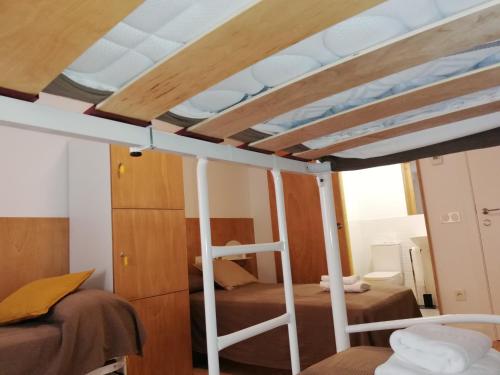 a bunk bed in a room with wooden walls at Hostel.B in Belorado
