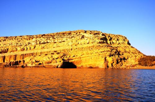 a cave in the side of a rocky cliff at Hotel Sofia in Matala