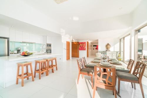 a kitchen and dining room with a table and chairs at Tropical Sea View Residence in Lamai