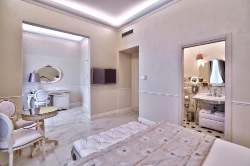 a bedroom with a vanity and a sink in a room at The Moon Boutique Hotel & Spa in Florence
