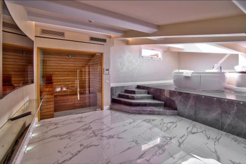 a bathroom with a tub and a sink and a bath tub at The Moon Boutique Hotel & Spa in Florence