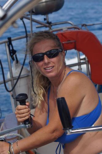 a woman in sunglasses is sitting on a boat at Play to Live San Blas in El Porvenir
