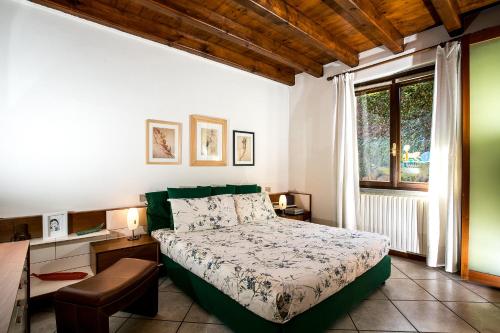 a bedroom with a bed and a window at Villa Eva in Meina