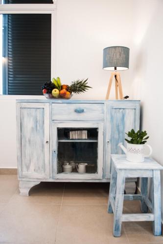 a blue cabinet with a bowl of fruit on top of it at Villa SCIROCCO Madeira - Ocean View in Machico