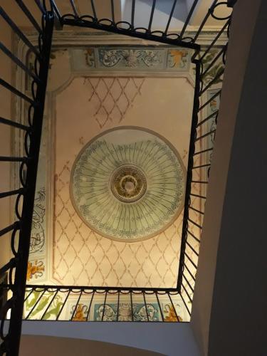 a ceiling in a building with a glass at Landolina Palace Hotel in Noto