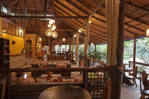 a lobby of a resort with a table and chairs at Amazon Ecopark Jungle Lodge in Manaus