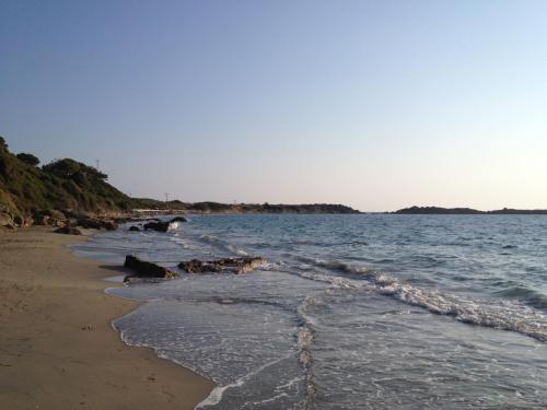 a beach with a couple of hearts in the water at Iris Apartments in Minia