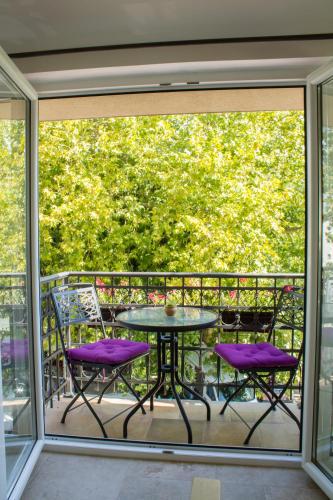 a patio with purple chairs and a table on a balcony at Vida`s house in Virpazar