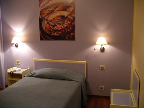 a bedroom with a bed and a painting on the wall at Hotel Antica Dogana in Turin