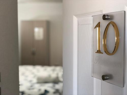 a white door with a number on it at Residencial Victoria Said in Linares