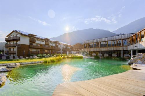 a river in the middle of a town with buildings at Ferienanlage Central in Flachau