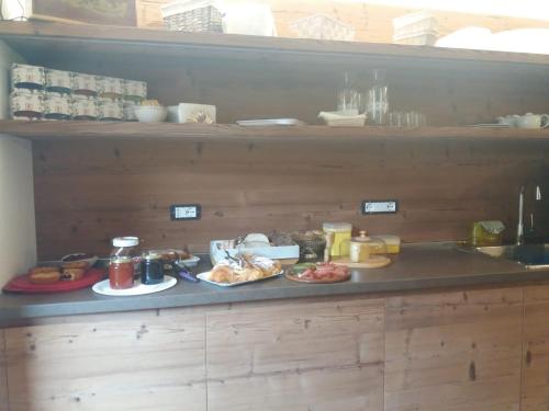 a kitchen counter with plates of food on it at B&B Al Castel in Padola