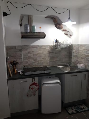 a small kitchen with a sink and a stove at La Stanzetta Dei Rosa in Portovenere
