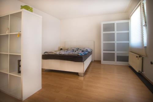 Un dormitorio con una cama y una estantería. en Altstadt Apartment Charly, en Düsseldorf