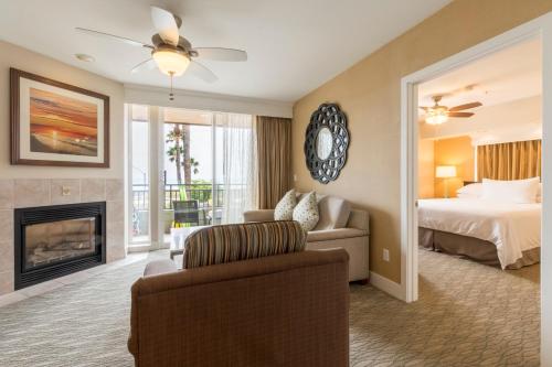 a living room with a bed and a fireplace at Carlsbad Seapointe Resort in Carlsbad