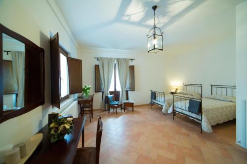 a living room with a bed and a table and chairs at Convento San Bernardino in Montefranco