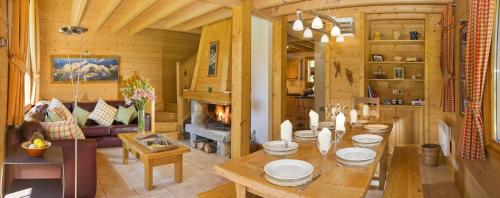 un salon avec une table et une cheminée dans l'établissement Chalet Rimaye - Chamonix, à Chamonix-Mont-Blanc