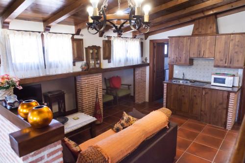 a living room with a couch and a fireplace at Casa Rural El Mendrugo in Tornadizos de Ávila