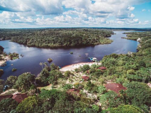 an aerial view of a river with trees and water at Amazon Ecopark Jungle Lodge in Manaus
