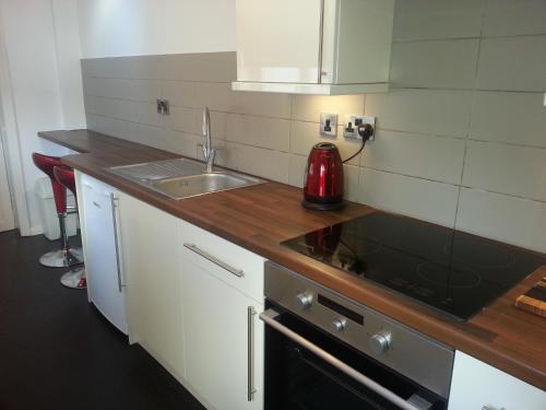 A kitchen or kitchenette at 45 The Square Holiday Apartments 