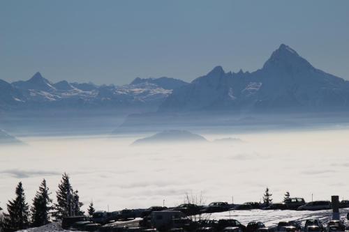 a view of a fog covered mountain range with mountains at Alpenhotel Weiherbach Berchtesgaden Hallenbad und Sauna in Berchtesgaden