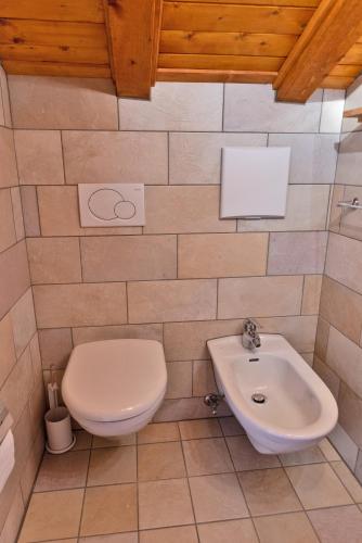 a bathroom with a toilet and a sink at Chesa Alvra - Celerina in Celerina