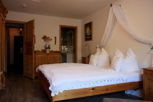 a bedroom with a large bed with white pillows at Schloß Destille in Dormagen