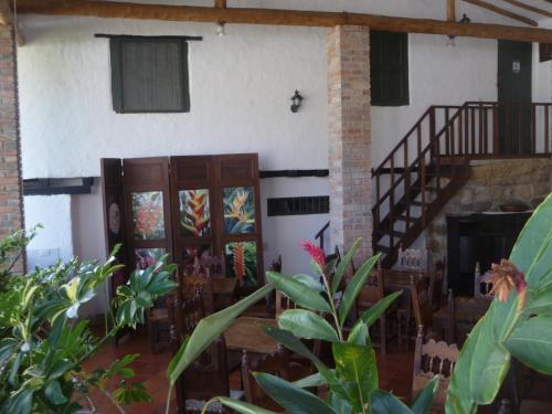 a room with wooden doors and a staircase with plants at Hotel Mision Santa Barbara RNT 4799 in Barichara