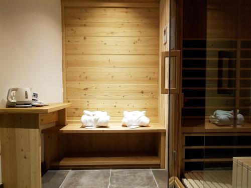 a sauna with towels sitting on a wooden shelf at Hotel Vandot in Kranjska Gora