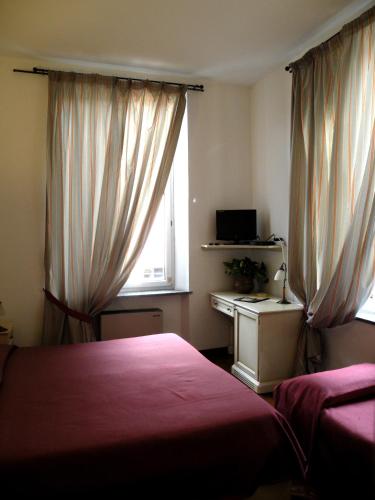 a bedroom with two beds and a window at Albergo Birra in Savignone