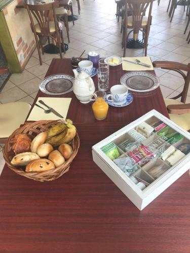 a wooden table with a basket of food on it at Auberge du val d’ouche in Bligny-sur-Ouche