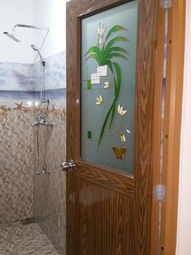 a bathroom with a shower with a wooden door at Brave resort Mirissa in Mirissa