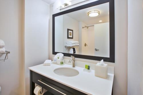 a bathroom with a sink and a large mirror at Best Western Plus Cranberry-Pittsburgh North in Cranberry Township