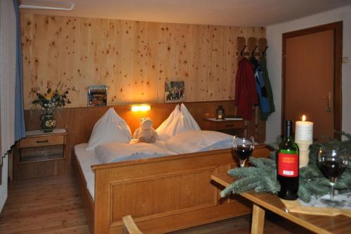 a bedroom with a bed with a teddy bear on it at Panoramapension Lerchner in Bad Kleinkirchheim