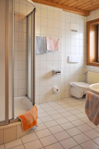 a bathroom with a shower and a toilet and a sink at Panoramapension Lerchner in Bad Kleinkirchheim
